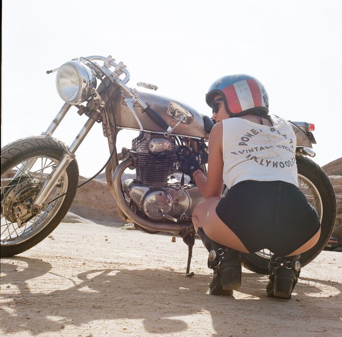 A playful frame from Girls on a motorcycle — online in Banjul